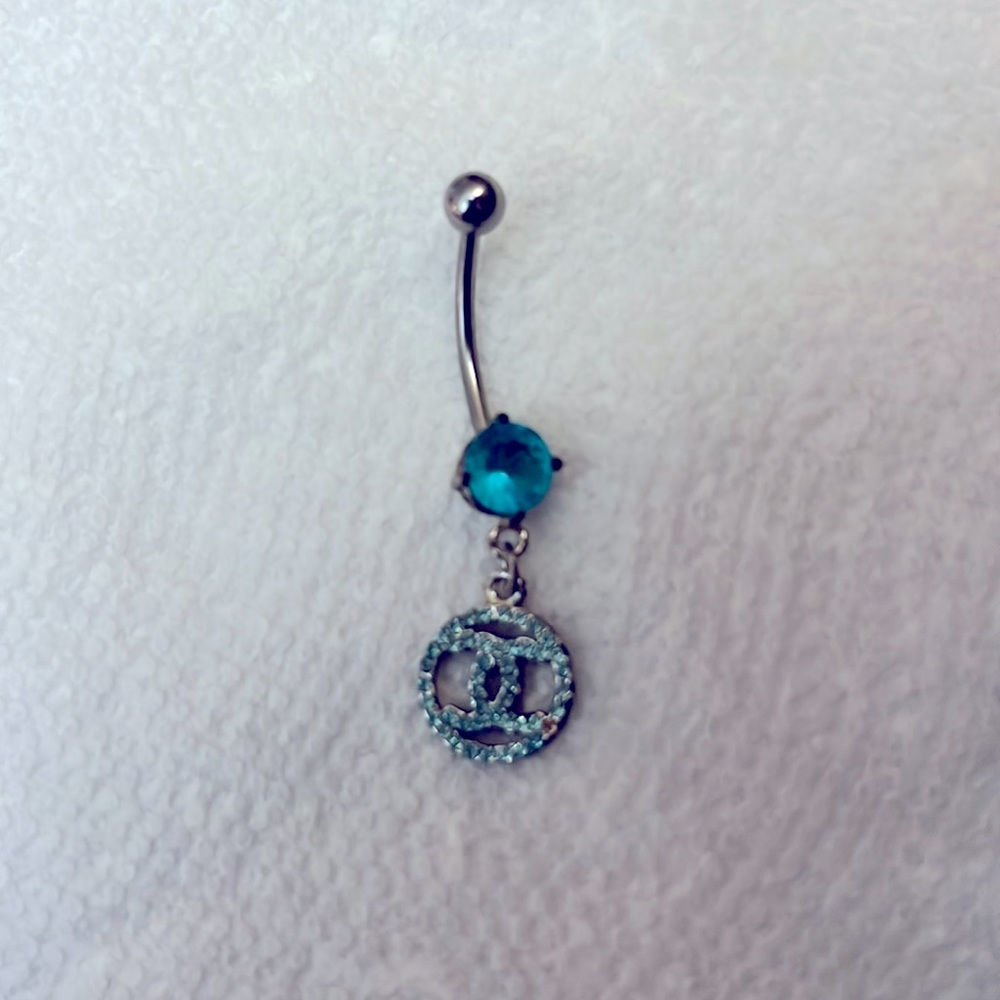 Double “C” belly ring with light blue rhinestones